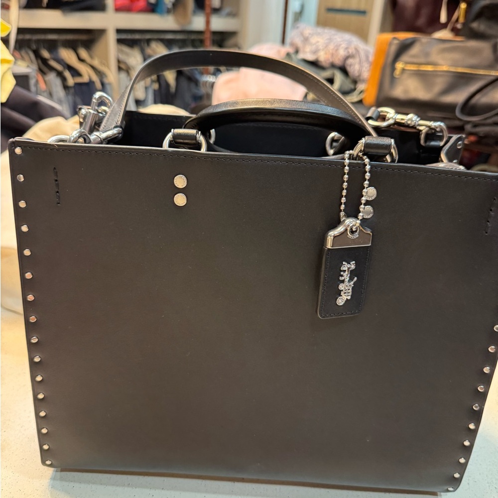 Coach rogue with rivets LIKE NEW. Carried one or twice. No flaws!
